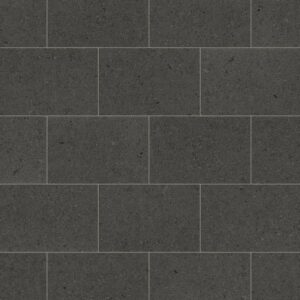 Procida limestone luxury vinyl tiles in dark charcoal with subtle aggregate pattern